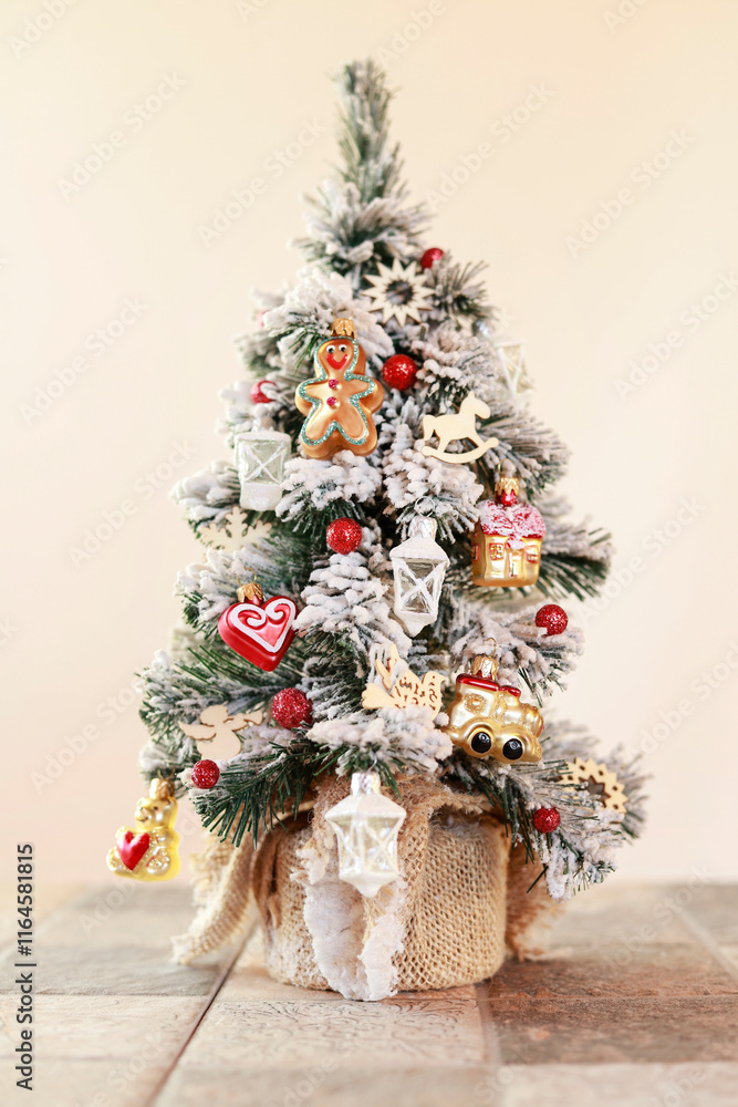 Small Christmas tree with tiny baubles and wooden pendants.
