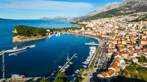 Makarska, a stunning coastal city on Croatia's Adriatic Sea, captured from the drone, reveals its breathtaking beauty. Nestled between the turquoise waters and the dramatic Biokovo Mountain photo