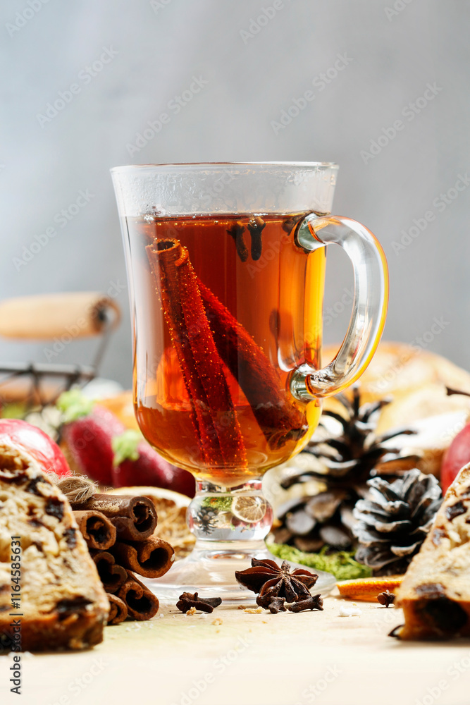 Glass of Christmas tea with cloves and cinnamon.
