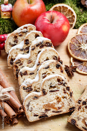 Delicious traditional strudel with dried fruit. Around the cake are beautiful classic Christmas decorations.