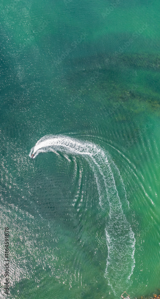 Speed boat in the sea with wake foam on clear water