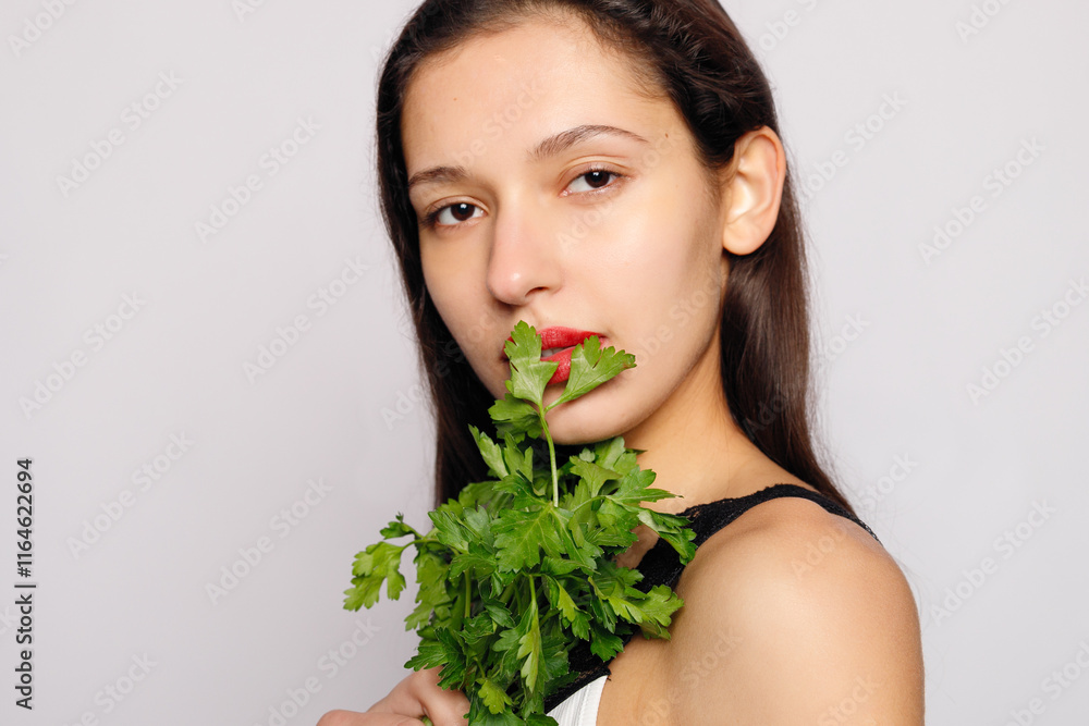 Beautiful smiling girl with parsley. Healthy lifestyle concept Beautiful smiling girl with parsley. Healthy lifestyle concept