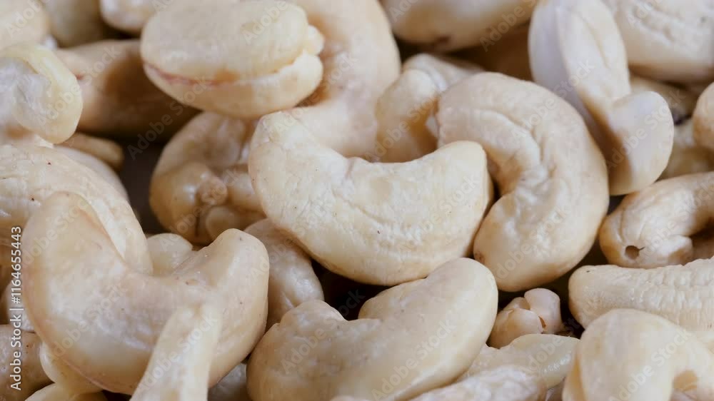 Close-up, slider shot of fresh cashew nuts in a heap. Depth of field, selective focus. Food, nutrition, healthy eating, snacks, ingredient concepts. 4k Close-up, slider shot of fresh cashew nuts in a heap. Depth of field, selective focus. Food, nutrition, healthy eating, snacks, ingredient concepts. 4k
