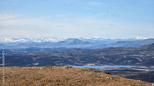 Photography Hiking in the Norwegian mountains in late autumn, snow-capped mountains visible