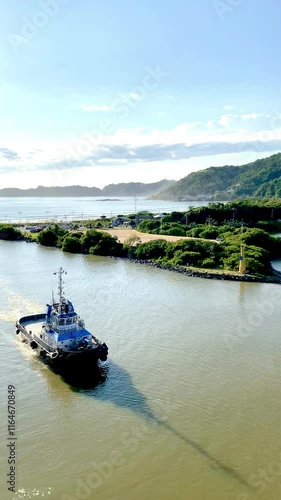 View of a tugboat aboard a cruise ship, supporting navigation in areas of greater danger. Special attention is paid to the intact nature and the difference in tones in the water due to different consi