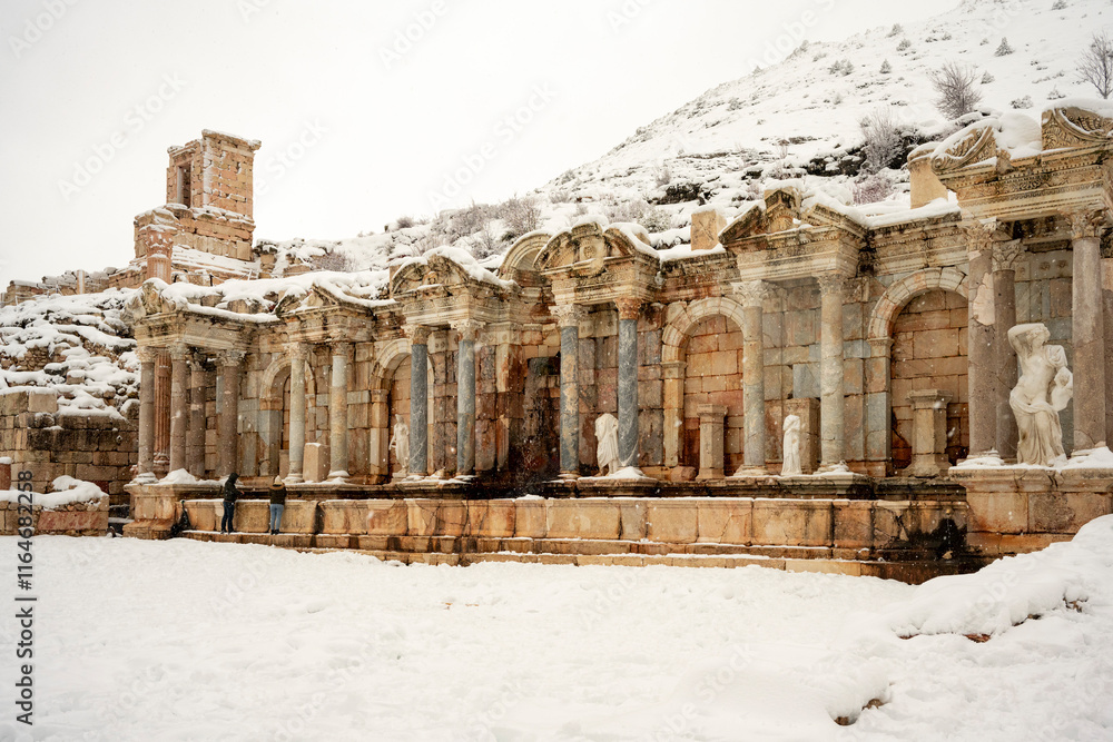Fototapeta premium o visit the sprawling ruins of Sagalassos, high amid the jagged peaks of Ak Dag, is to approach myth: the ancient ruined city set in stark . Sagalassos Ancient City under the snow on a winter day.