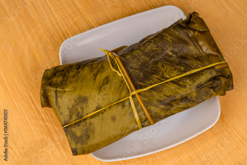 Colombian tamale recipe with steamed banana leaves photo