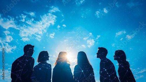 Silhouetted group looking up at bright sun.