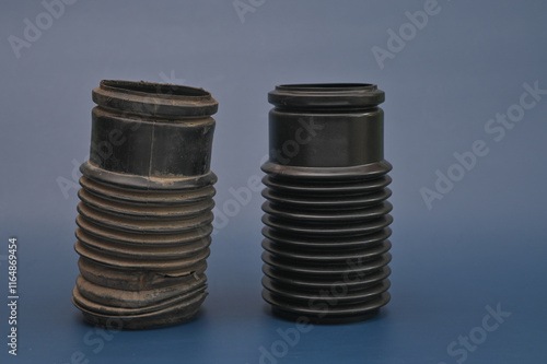 new and old cover for a car shock absorber. on a blue background photo