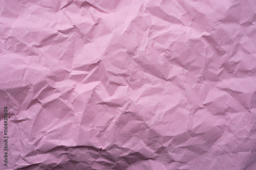 Fototapeta premium Full frame shot of crumpled pink paper sheet texture and background.