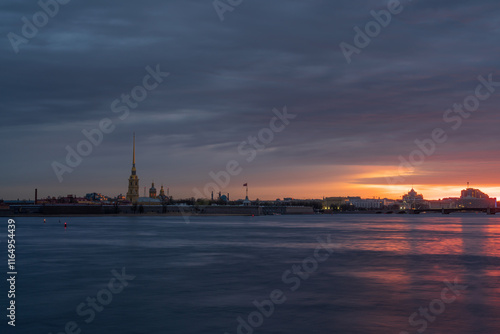 View of the Peter and Paul Fortress and the Neva River against a pink dawn sky with clouds on a sunny spring morning, St. Petersburg, Russia