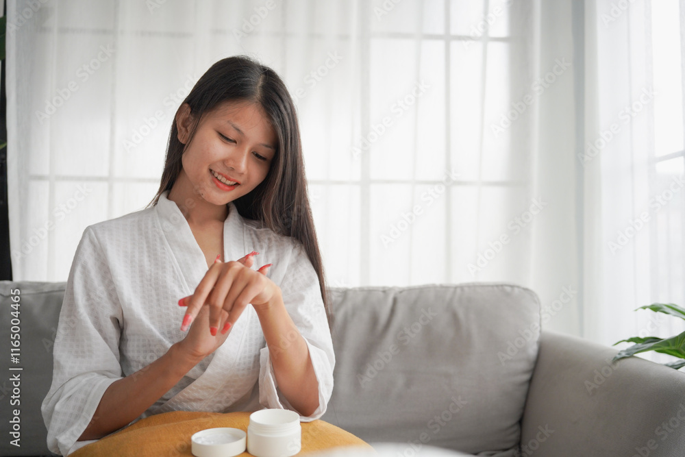 Asian woman in bathrobe applying skincare, take care of your facial skin Asian woman in bathrobe applying skincare, take care of your facial skin