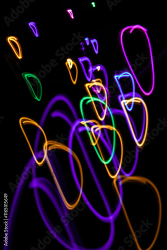 Light painting. Neon glow. Symmetry and reflection. Festive decoration. Abstract blurred background. Shining pattern.