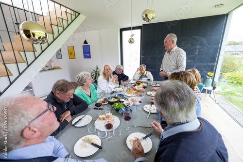 Savoring and enjoying a delightful communal meal with loved friends and family in a bright, modern setting