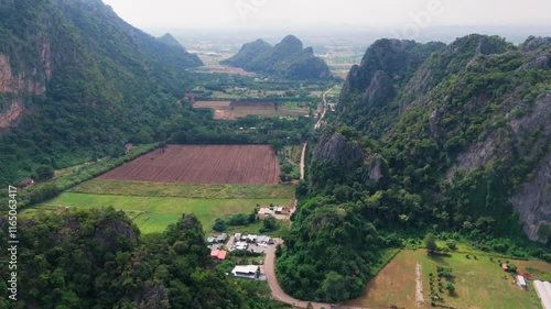 Aerial of Ban Chai Khao limestone mountains in Thailand Uthai Thani province , drone fly above famous Thai-Switzerland agricultural field rice plantation photo