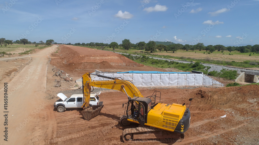 Yellow Excavator Working Near Culvert Construction Site Yellow Excavator Working Near Culvert Construction Site