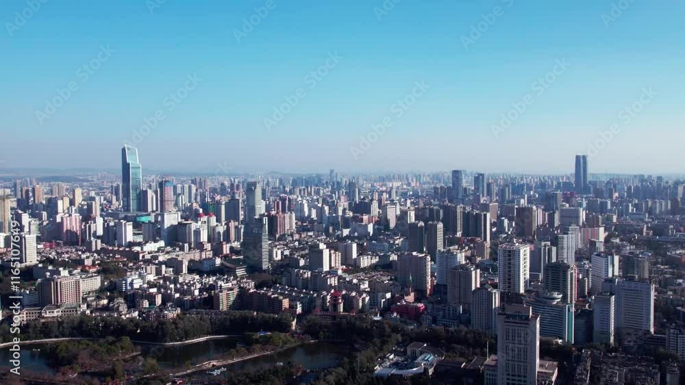 Explore the vibrant skyline of Kunming on a sunny day showcasing the urban atmosphere and stunning city views Explore the vibrant skyline of Kunming on a sunny day showcasing the urban atmosphere and stunning city views