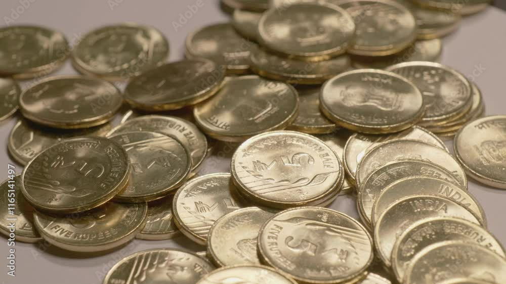 indian currency golden 5 rupee coins scattered on the table , 4k close up, orbit shot indian currency golden 5 rupee coins scattered on the table , 4k close up, orbit shot