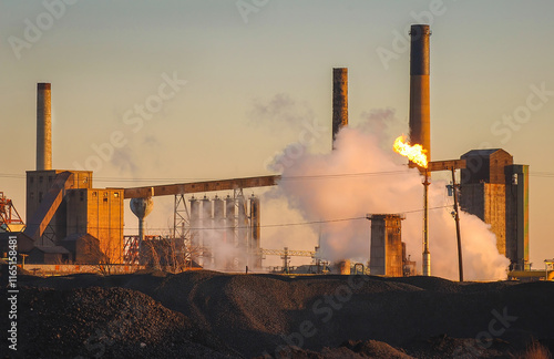 Working steel mill at dawn on Detroit River industrial shoreline