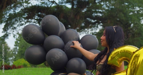 A young woman celebrates her 24th birthday on a vibrant golf course in Trinidad's tropical Caribbean setting. photo