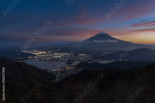 Beautiful evening aerial view of Mount Fuji and Lake Kawaguchi with colorful sky and city lights, Yamanashi, Japan photo