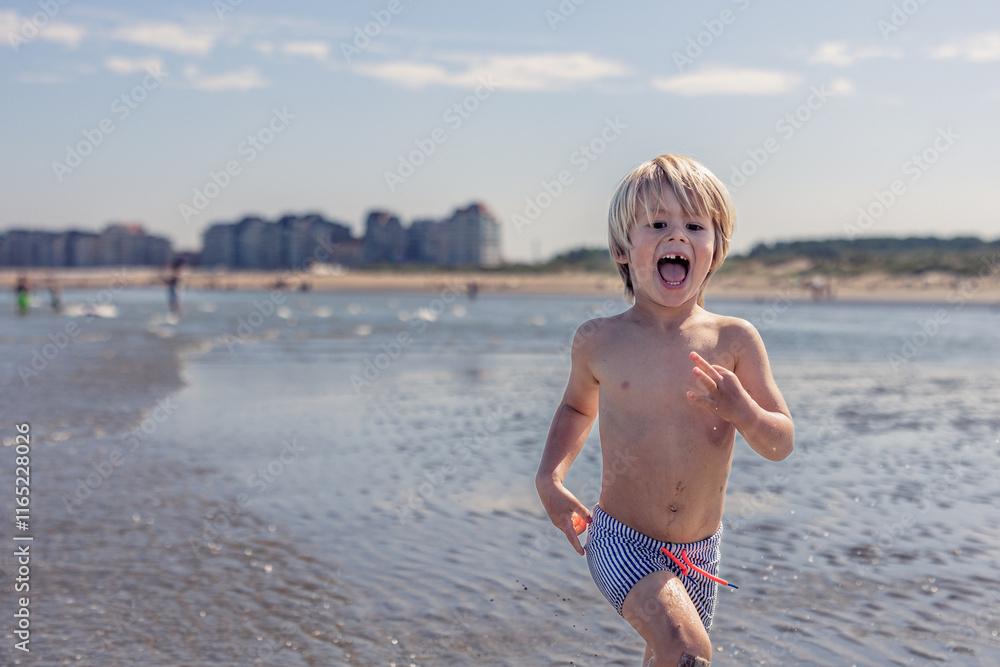Happy boy running through shallow waves on the beach. Happy boy running through shallow waves on the beach.