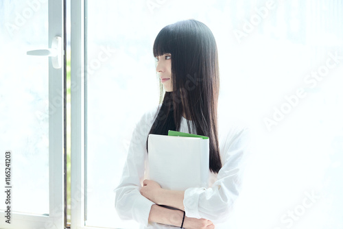 Free Download Female college student near the classroom window - GFXLoad