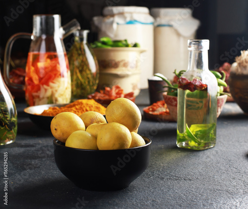 lemon bowl with spices & oils Ready to Cook, Pickle ingredient on dark background, banner, menu, recipe, top view. photo