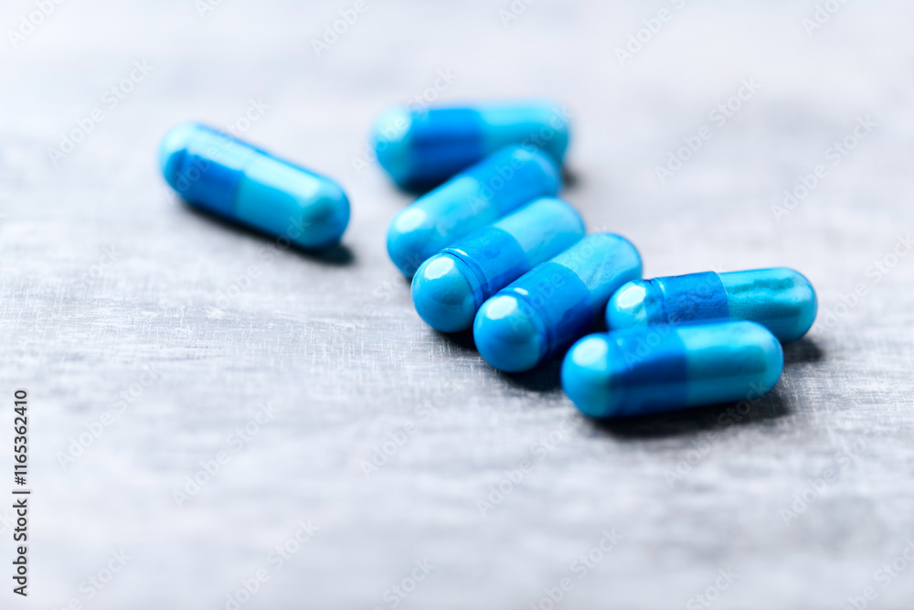 Amino acids capsules on bright wooden background. Soft focus. Close up. Copy space. Amino acids capsules on bright wooden background. Soft focus. Close up. Copy space.