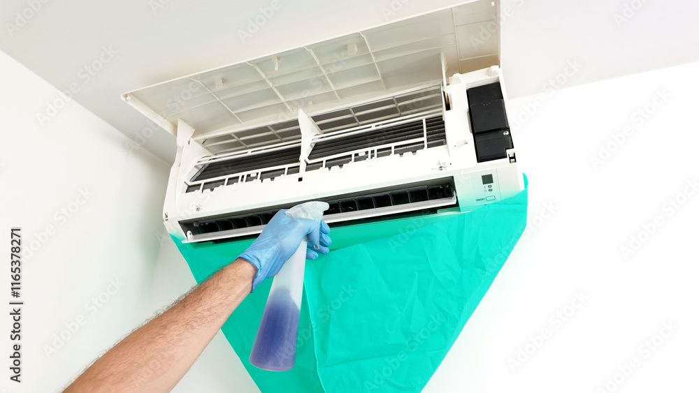 Man cleaning and maintaining air condition unit at Man cleaning and maintaining air condition unit at home. Man cleaning and maintaining air condition unit at Man cleaning and maintaining air condition unit at home.
