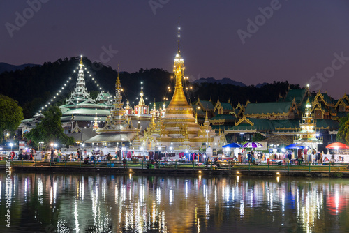 Wat Jong Kham and Wat Jong Klang temples on the lake at dusk, Mae Hong Son in Thailand photo