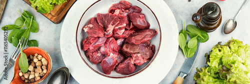 Raw deer venison prepared for a cooking process. photo