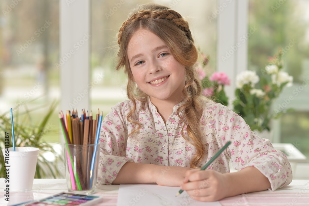 Cute smiling little girl drawing at home Cute smiling little girl drawing at home