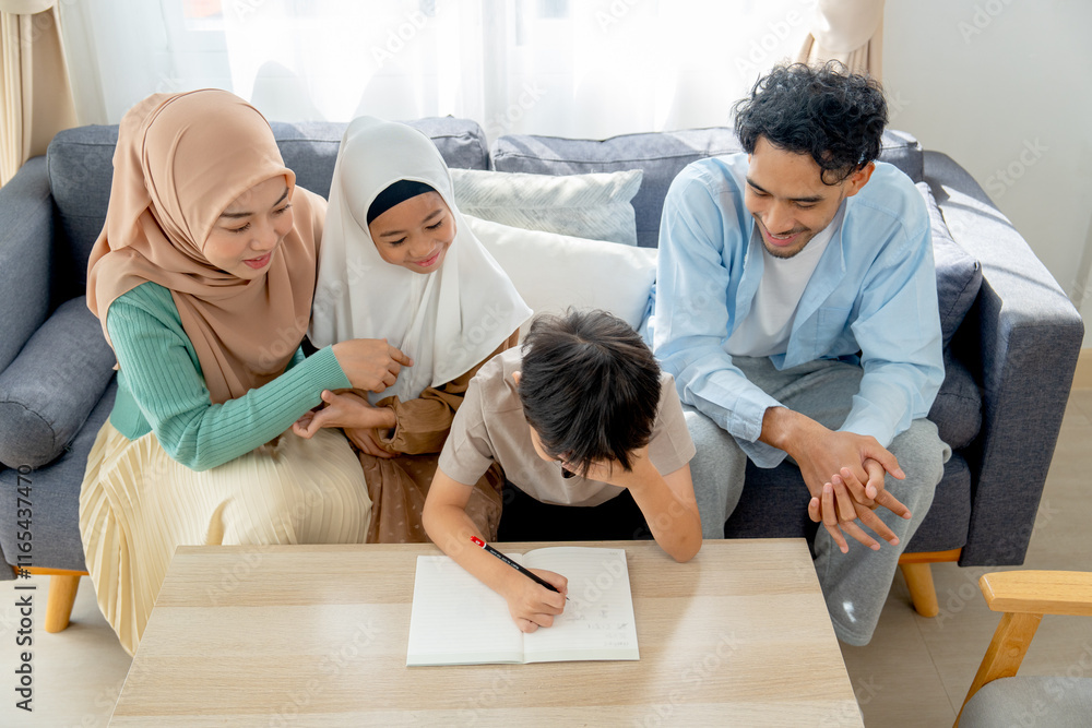Asian little boy express serious during write puzzle game for playing with his older sister and joy with the family at home. Asian little boy express serious during write puzzle game for playing with his older sister and joy with the family at home.