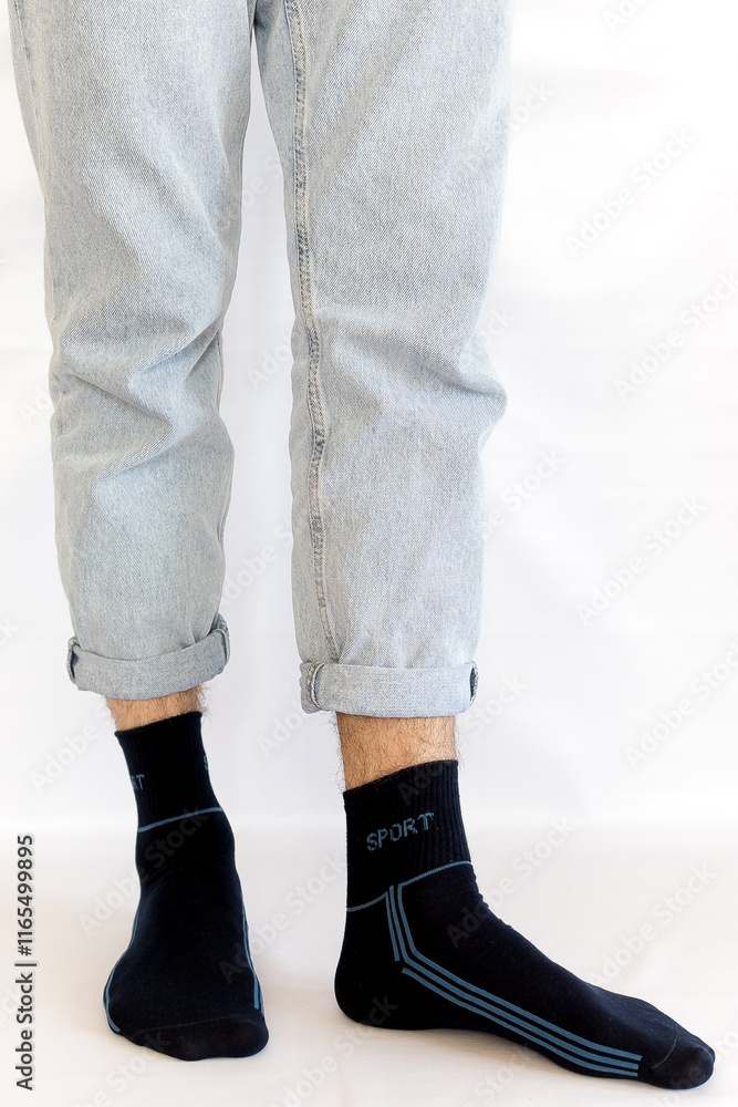 Man in stylish black socks on light white background, closeup.rear view, heel view Man in stylish black socks on light white background, closeup.rear view, heel view