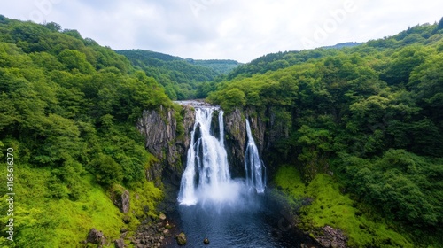 A scenic view of a cascading waterfall surrounded by lush greenery.