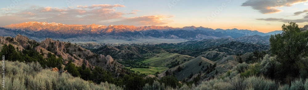 A panoramic view of beautiful mountains, with a green valley below, illuminated by the golden hour sun lighting the peaks A panoramic view of beautiful mountains, with a green valley below, illuminated by the golden hour sun lighting the peaks