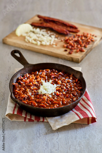 simmered baked beans served in a cast iron skillet photo