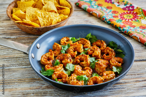 taco style shrimp served with a coconut chili sauce served in a skillet
