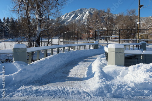 Trail bridge covered with fresh snow, Boulder, Colorado photo