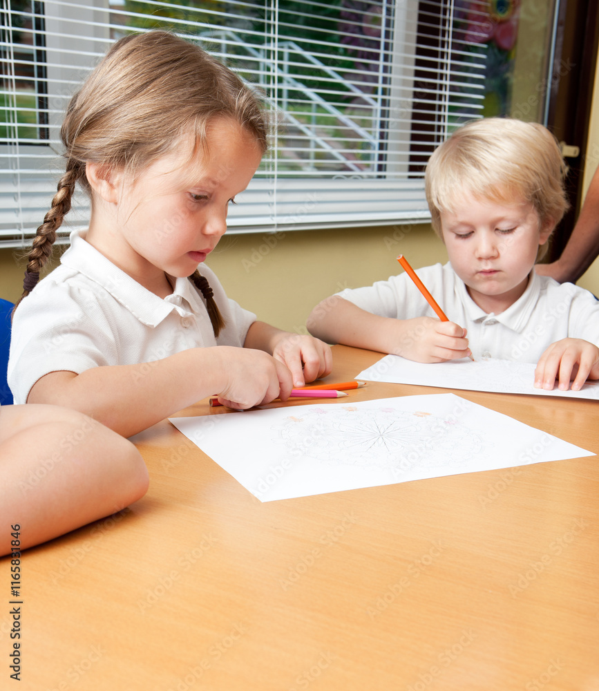 Elementary School: Working Together. A pair of young primary school children concentrating on the work set to them by their classroom teacher. Elementary School: Working Together. A pair of young primary school children concentrating on the work set to them by their classroom teacher.