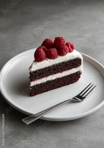 Chocolate cake with raspberries served on a white plate
