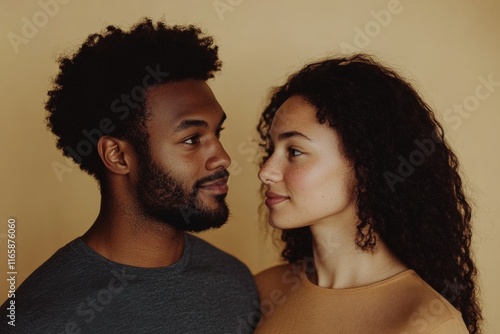 diverse interracial couple looking at each other with affection and respect, on a simple, color neutral background photo