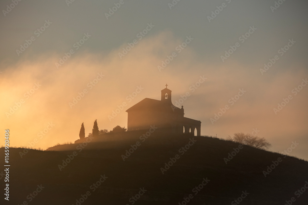 Obraz premium View of the hermitage of Santa Quiteria on a hill in an idyllic sunrise with golden light in Cuenca, Spain