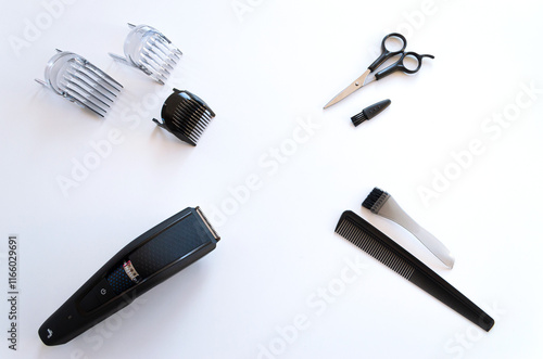 Kit de barbero con máquina cortapelos, tijeras, peines y cepillos. Plano desde arriba o cenital.  photo