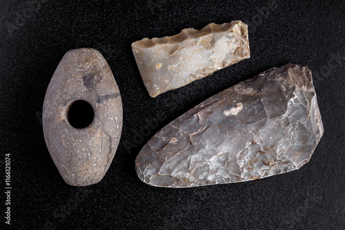 Photography Prehistoric stone axe, isolated on black background