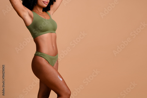 Cropped photo of lady raise hands near empty space applying anti cellulite therapy cream isolated pastel color background