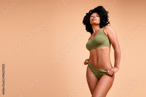 No filter studio photo of slender pretty woman underwear enjoying self acceptance empty space isolated beige color background