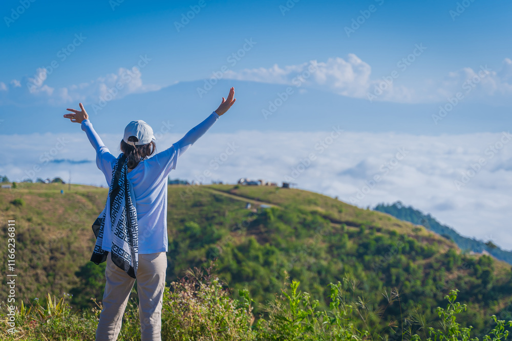Asian woman relaxing in the morning with beautiful nature scenery of the sea of mist at Campground of Doi Ba Lu Kho Mountain viewpoint in Mae Chaem, Chiang Mai, Thailand. recreation background. Asian woman relaxing in the morning with beautiful nature scenery of the sea of mist at Campground of Doi Ba Lu Kho Mountain viewpoint in Mae Chaem, Chiang Mai, Thailand. recreation background.