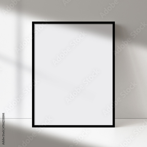 Black picture frame art, poster, or painting mock-up with blank canvas, soft natural light, and shadow on a neutral wall. Perfect for showcasing artwork or designs.